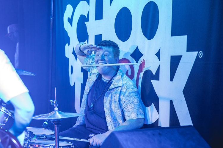 School of Rock student drummer on stage